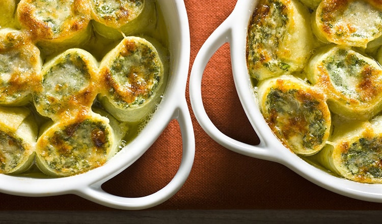 Crepes rings stuffed with ricotta cheese and spinach, topped with Parmigiano and butter and gratinÈ.