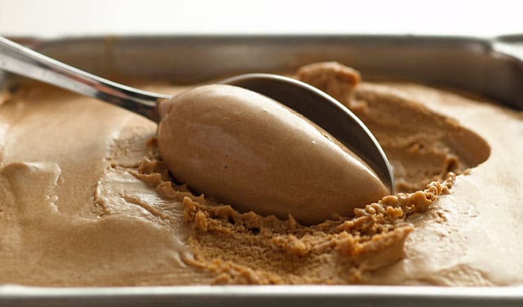 Coffee ice cream being scooped with a spoon