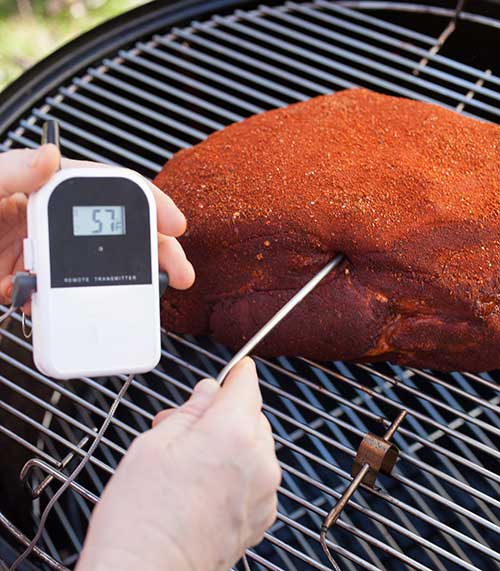 Thermometer in roast on grill