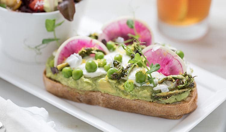 Tartine with ricotta, green peas, and radishes