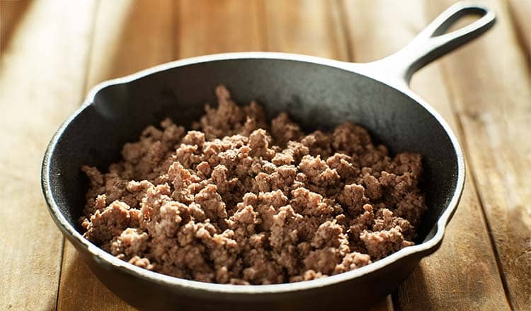 Cast iron skillet with cooked ground meat