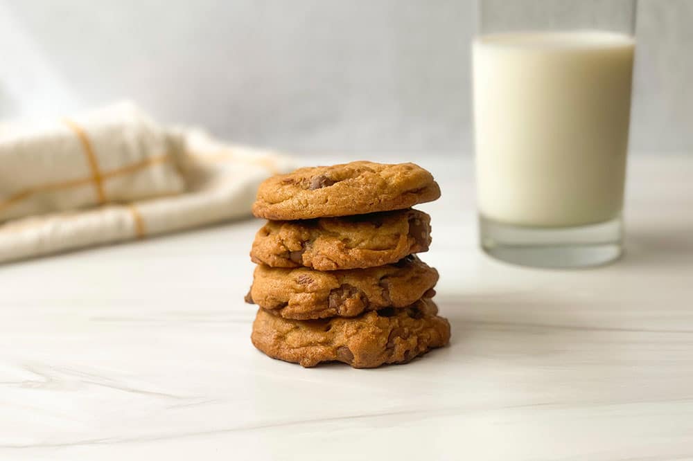 Brown Sugar Chocolate Chip cookies with glass of milk in the background