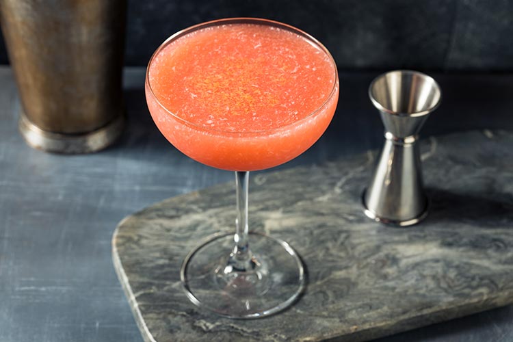 Frozen paper plane cocktail in a coupe glass