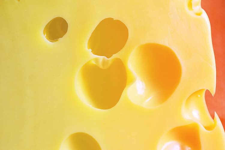 Close up of holes in Swiss cheese