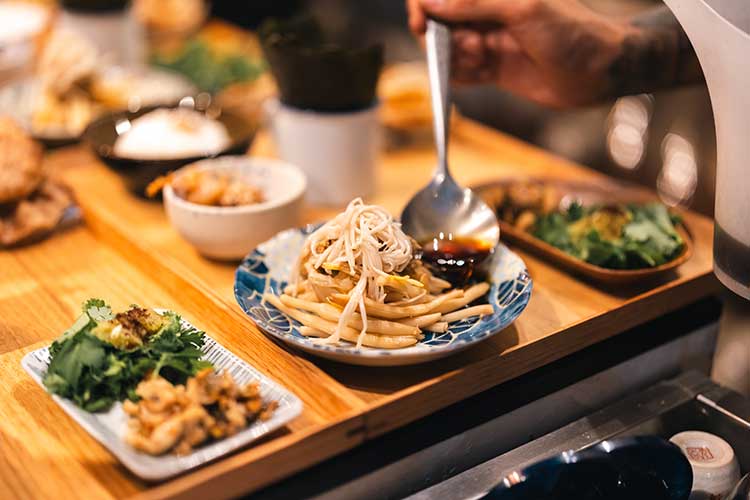 A table with noodles and other savory dishes